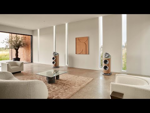 A lounge room with two boucle white chairs and featuring a pair of Bowers & Wilkins 804 D4 Floorstanding Speakers from Todds Hi Fi